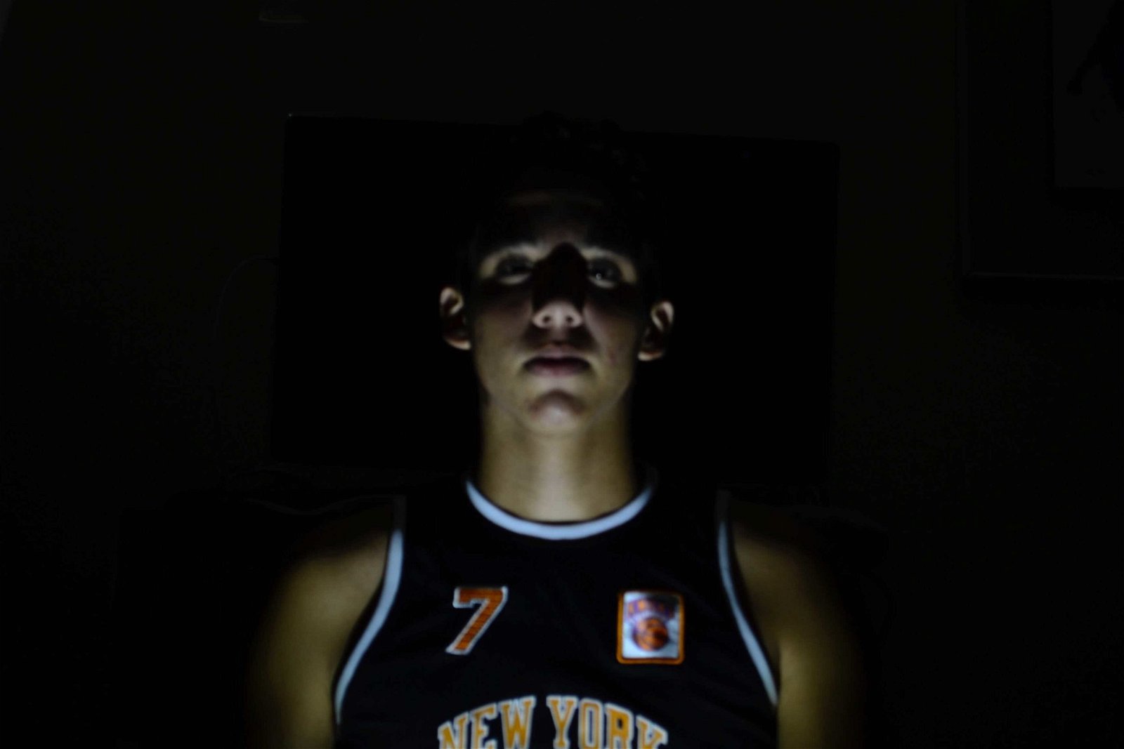 Underlighting is a portrait photography lighting technique that can create a heroic image--as seen in this photo of a basketball player--or a villainous image by lighting the subject from underneath